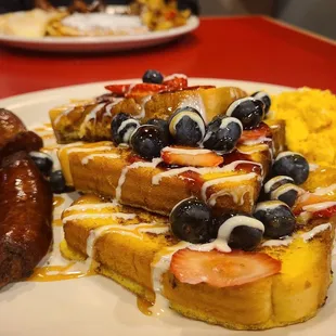 a plate of waffles and fruit