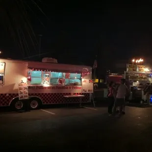 food trucks lined up in a parking lot