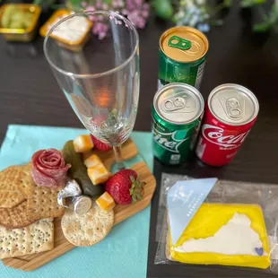 Individual charcuterie boards, real champagne glass, Perrier water, sprite, coke and VA sugar cookie from TASTE