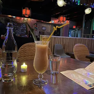 a table with drinks and a menu