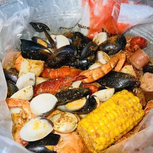 a bowl of seafood and corn