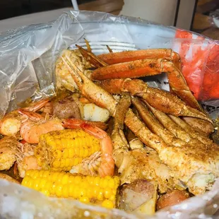 crab legs, corn on the cob, and corn on the cob