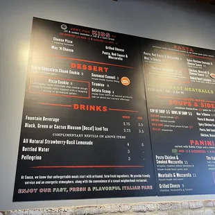 a menu on a brick wall