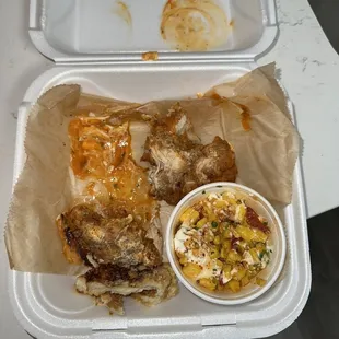 a tray of food with a side of coleslaw