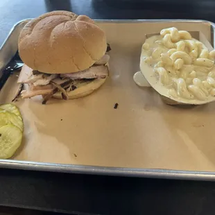 Smoked Turkey breast sandwich with mac and cheese.