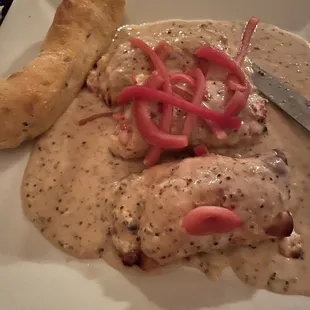 a plate of food with bread and a knife