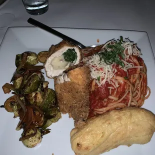Stuffed chicken with a side of vegetables served with linguine. Yum!