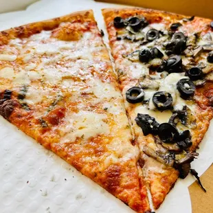 Two slices to go - cheese pizza and mushrooms and black olives