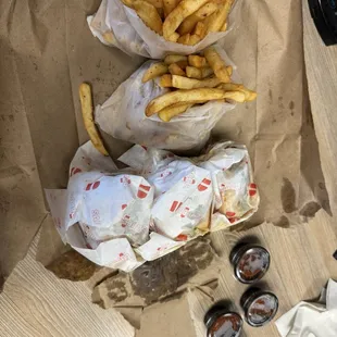 Three burgers and two fries for take out.