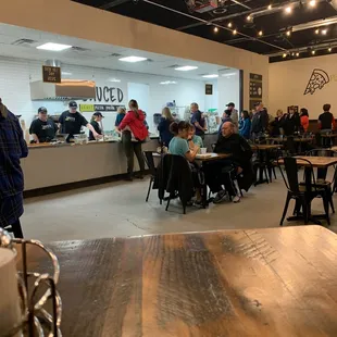 a large group of people sitting at tables in a restaurant