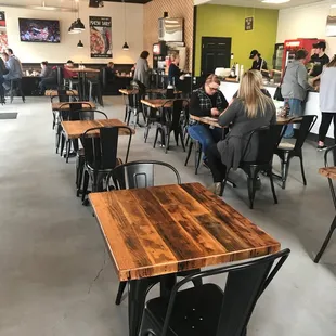 people sitting at tables in a restaurant