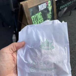 a person holding a bag of food