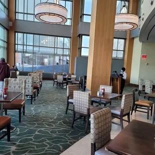 a view of a dining area with tables and chairs