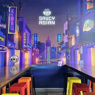 a view of a street with neon signs