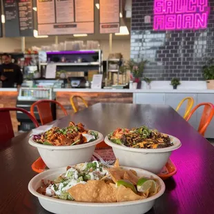 three bowls of food on a table