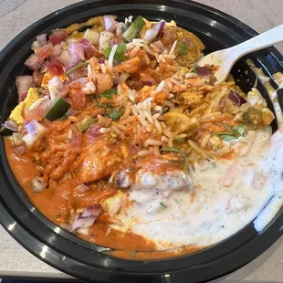 Korma and chicken tikka masala bowl with toppings.