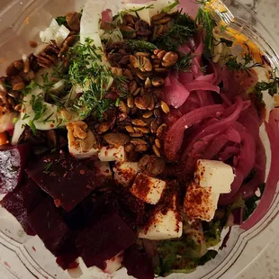 Vibrant salad, beets, feta cheese, marinated onions, muhammara (roasted red pepper) sauce