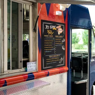 a food truck with a menu on the side