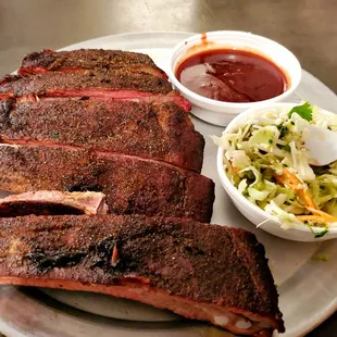 1/2 rack of ribs with sauce on the side and small slaw