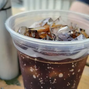 ows a cup of iced coffee