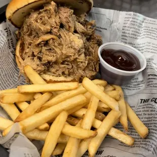 a pulled pork sandwich and french fries