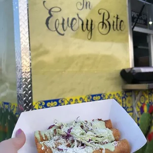 taquitos with the food truck behind it
