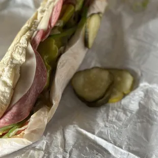 a sandwich with pickles and a pickle