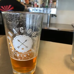a glass of beer on a counter