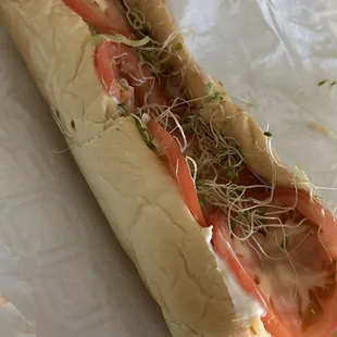 tomato and sprouts on a bun