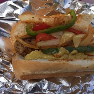 a hot dog with peppers and onions