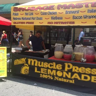a vendor selling sausages and lemonade