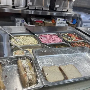 Macaroni salad, potato salad, side salad, pico de gallo, crazy hot dogs, and Salvadoran chicken sandwiches.