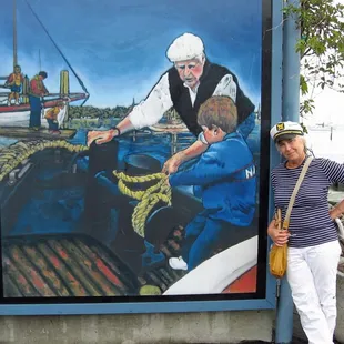Victoria Colella with her mural at Clipper Yacht Harbor
