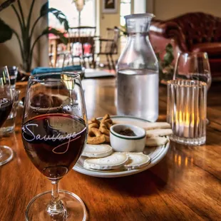 a glass of wine and a plate of cookies