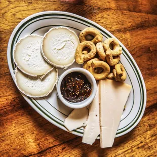 a platter of cheese, crackers, and nuts