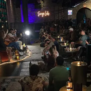 a group of people sitting in a bar