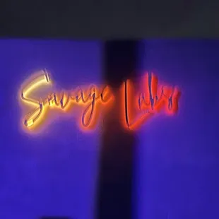 a neon sign that reads savage labs