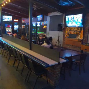 a bar with chairs and tables