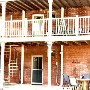 Back of the BNB with a Balcony with seating.