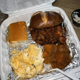 a tray of food including a sandwich, macaroni and cheese