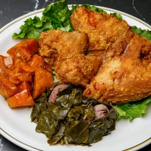a plate of fried chicken and vegetables