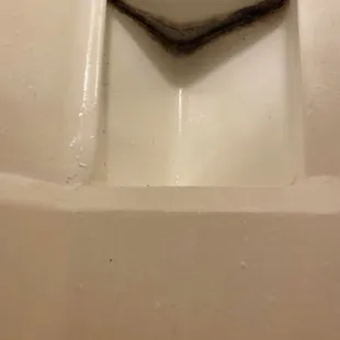 Crusty inside of bath tub. It was like this when I moved in.