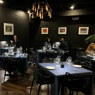 people sitting at tables in a restaurant