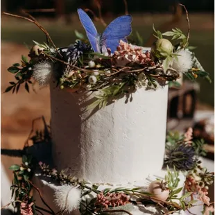 Whimsical woodland themed wedding cake with edible butterflies