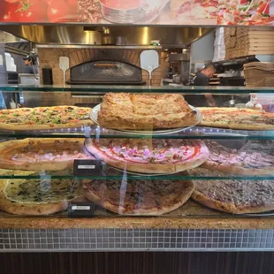 a display of pizzas in a restaurant