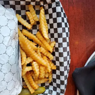 Fries with a chicken parmesan sandwich
