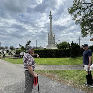Tour guide, Glenn Schiro, explaining the history of a large obelisk at Lake Lawn Metairie Cemetery.