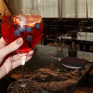 The Blueberry Limoncello Spritz was made with limoncello siciliano, blueberry syrup, Aperol, &amp; prosecco.