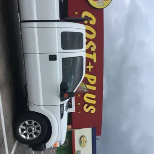 a white truck parked in front of a restaurant