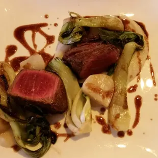 a plate of food with meat and vegetables
